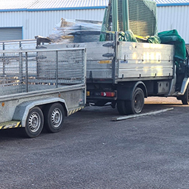 Commercial waste management truck with green and yellow cab