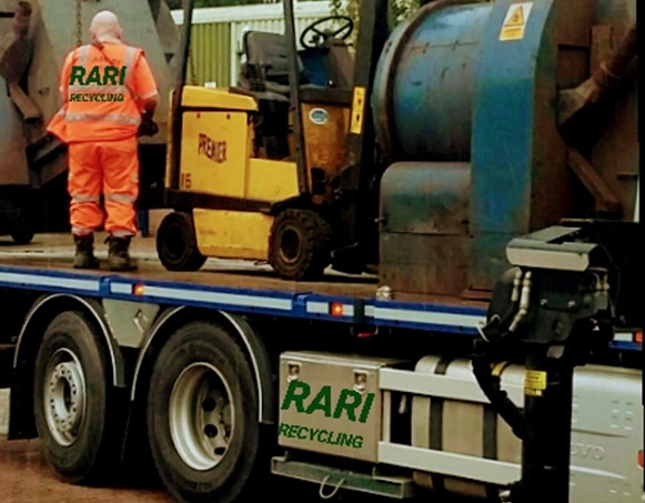 Rari Recycling worker operating forklift with recycling drums